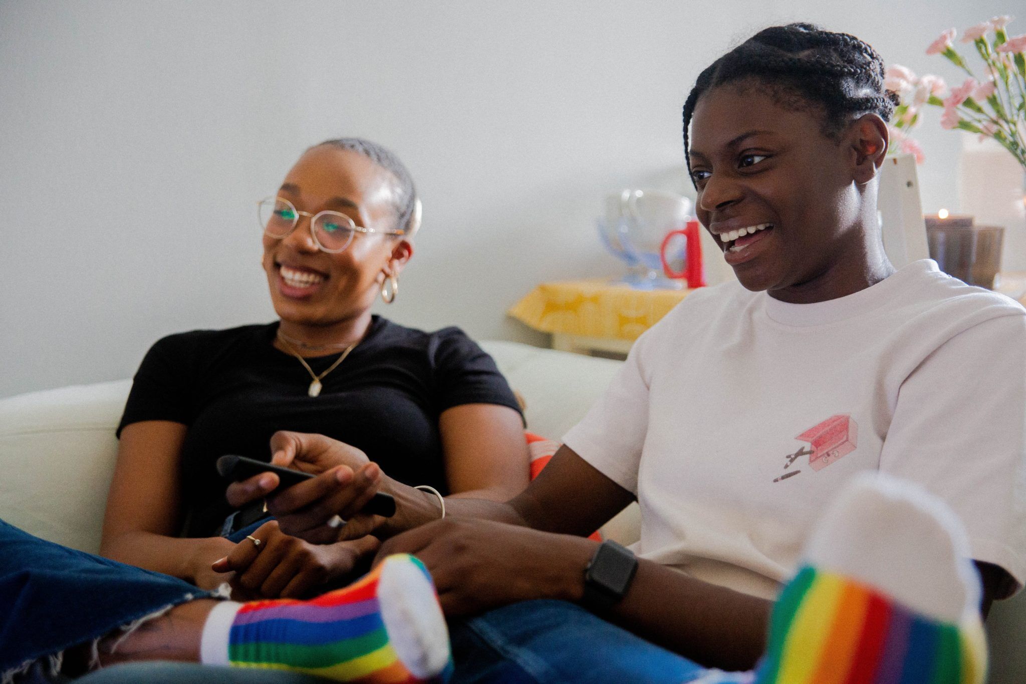 lgbt couple on couch smiling