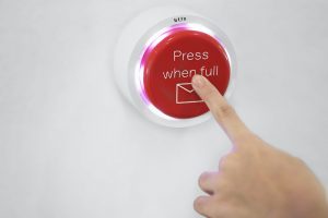 person pushing a big red button that says "full"