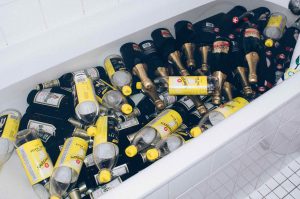 bathtub full of empty alcohol and tonic bottles