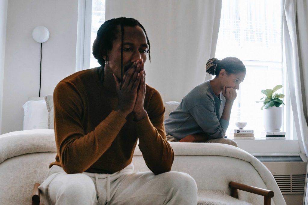 Unhappy couple facing away from each other and brooding