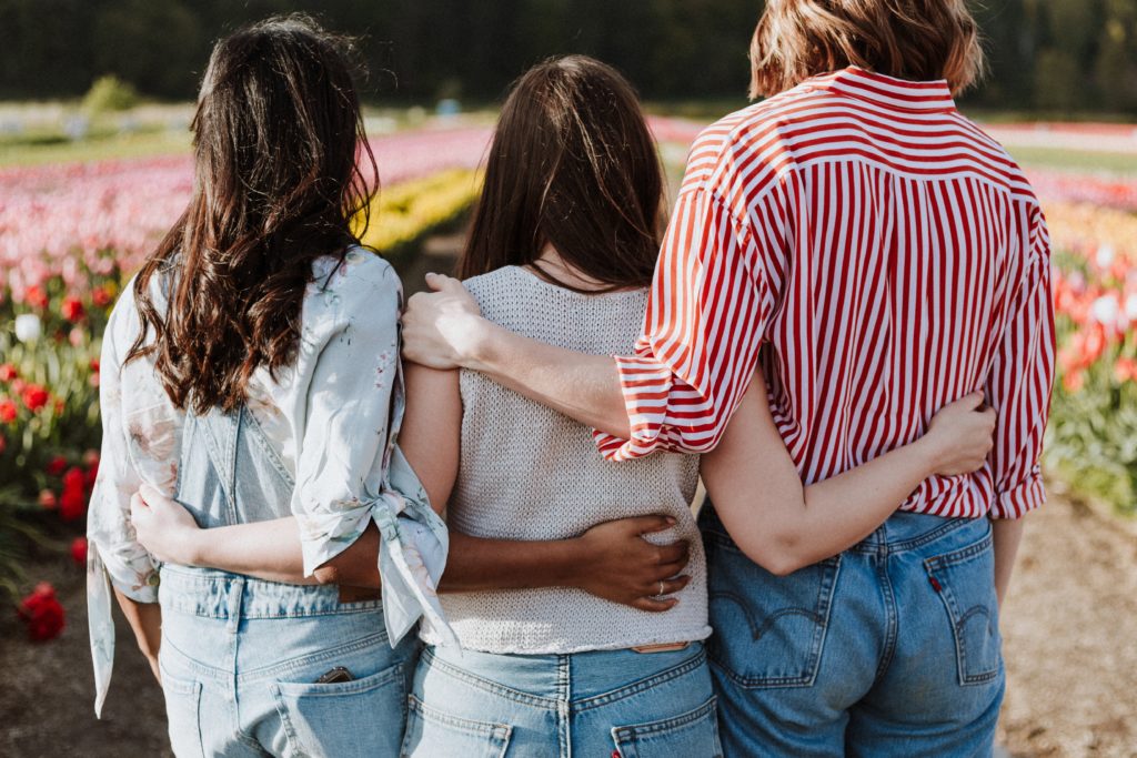 children of alcoholics, girls holding hands in a field