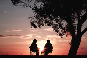 recovery coaching: two people talking at sunset