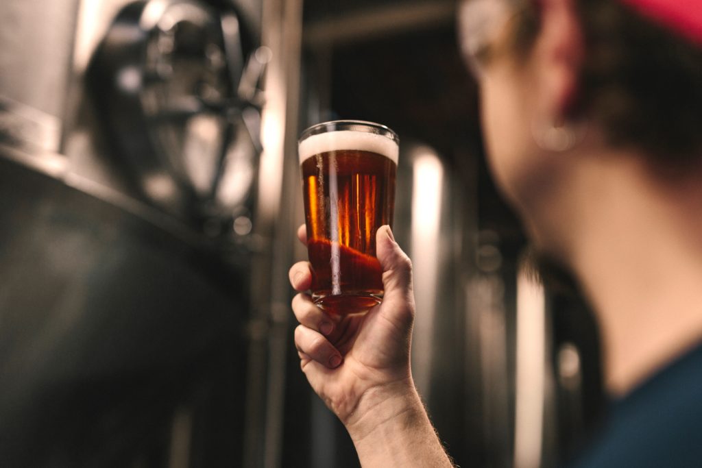 long hours and risky drinking Man holding beer