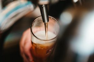 long hours and risky drinking pouring beer