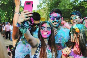 sober socializing people covered in colored powder
