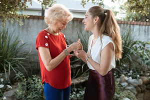 older and younger woman sharing joyful news