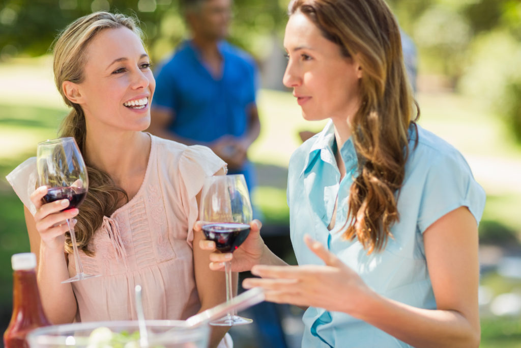 women moderately drinking wine