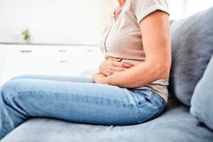 how alcohol affects your health woman clutching stomach