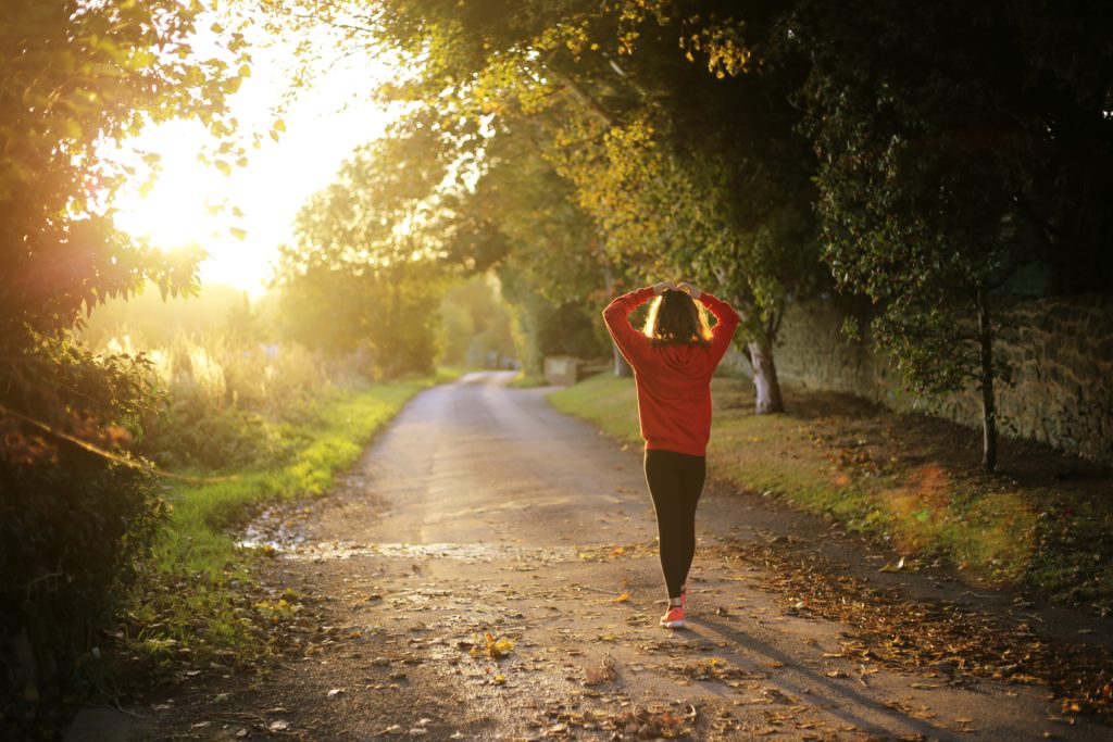 national recovery month woman walking on forest road