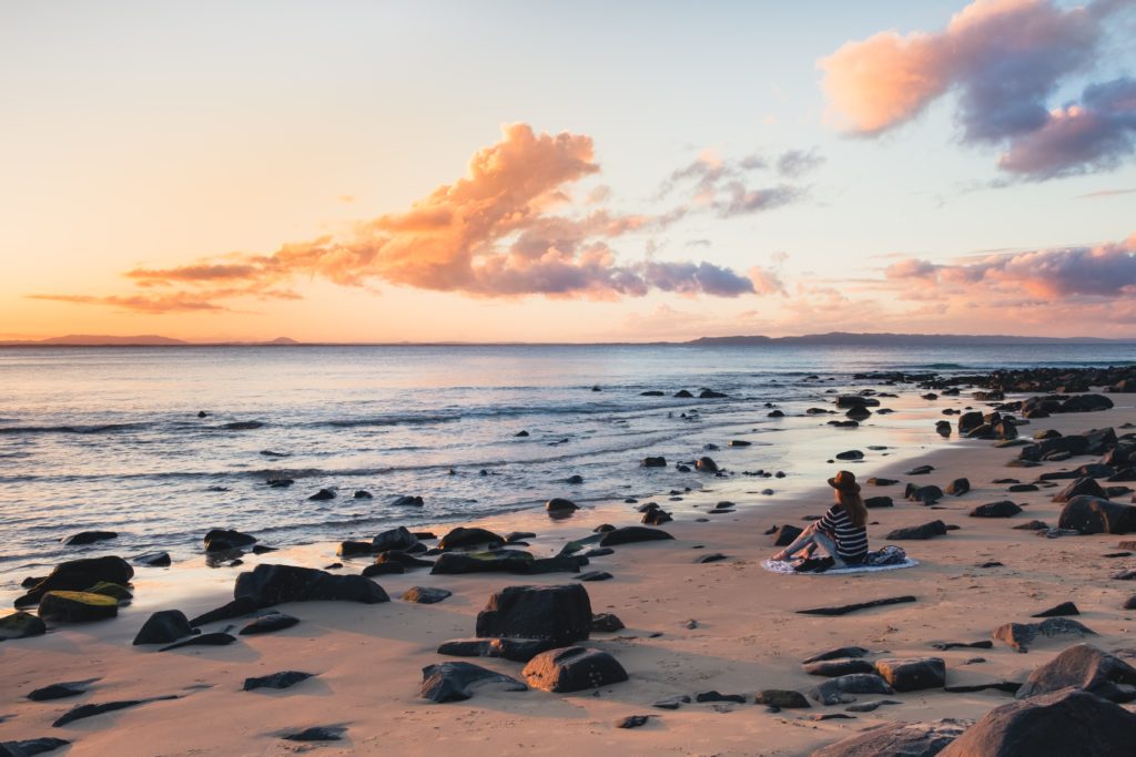 mental health apps sitting on the beach