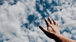 mental health apps hand reaching towards the sky