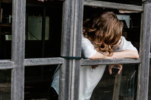 mental health apps woman in wooden door frame