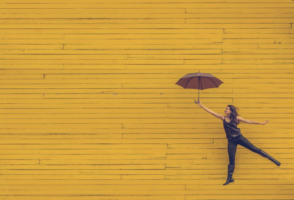 recovery quotes woman jumping with umbrella