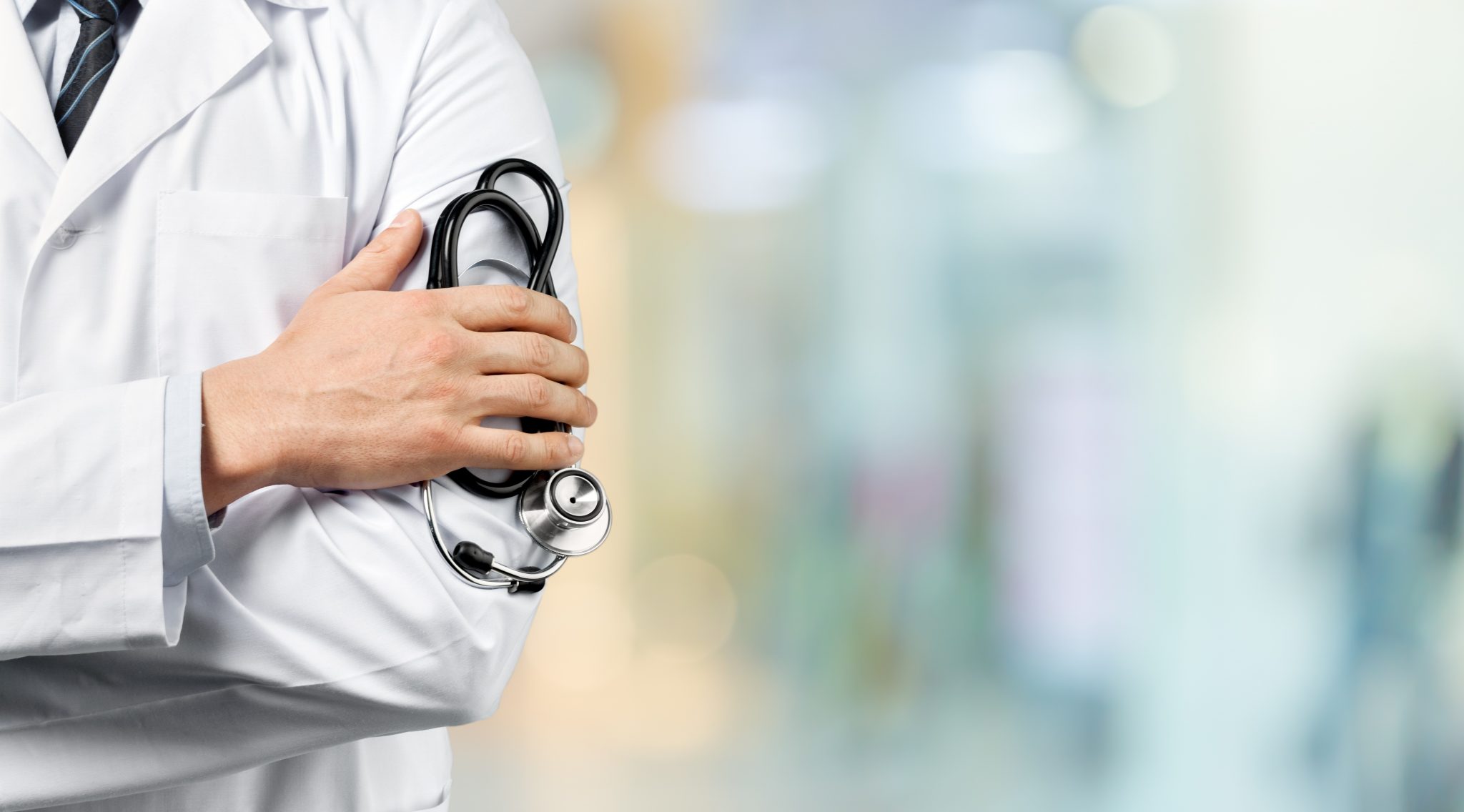 doctor standing with folded arms, health plans