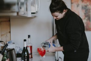 woman pouring drinks, signs of alcoholism