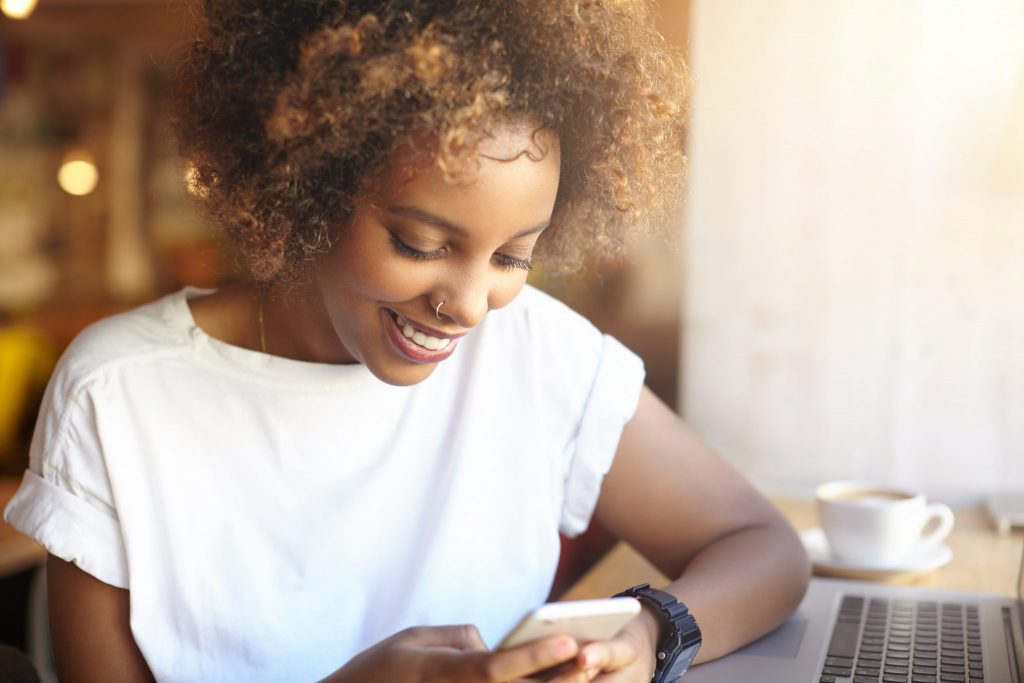 young woman on smartphone in cafe, sample member