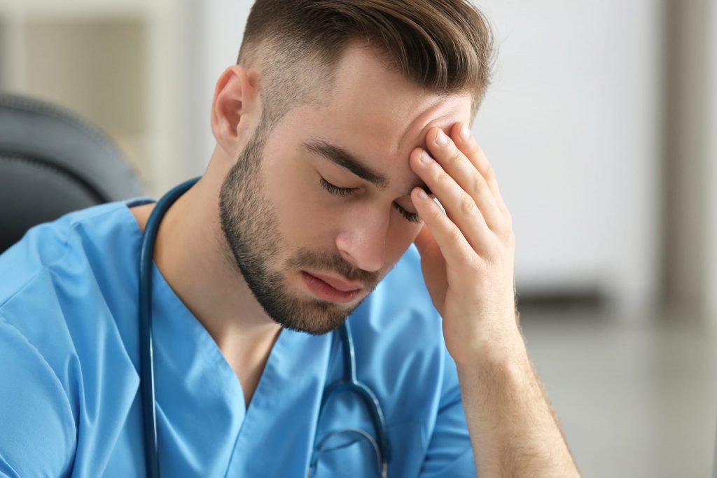 Male ER nurse experiencing stress, sample Ria member