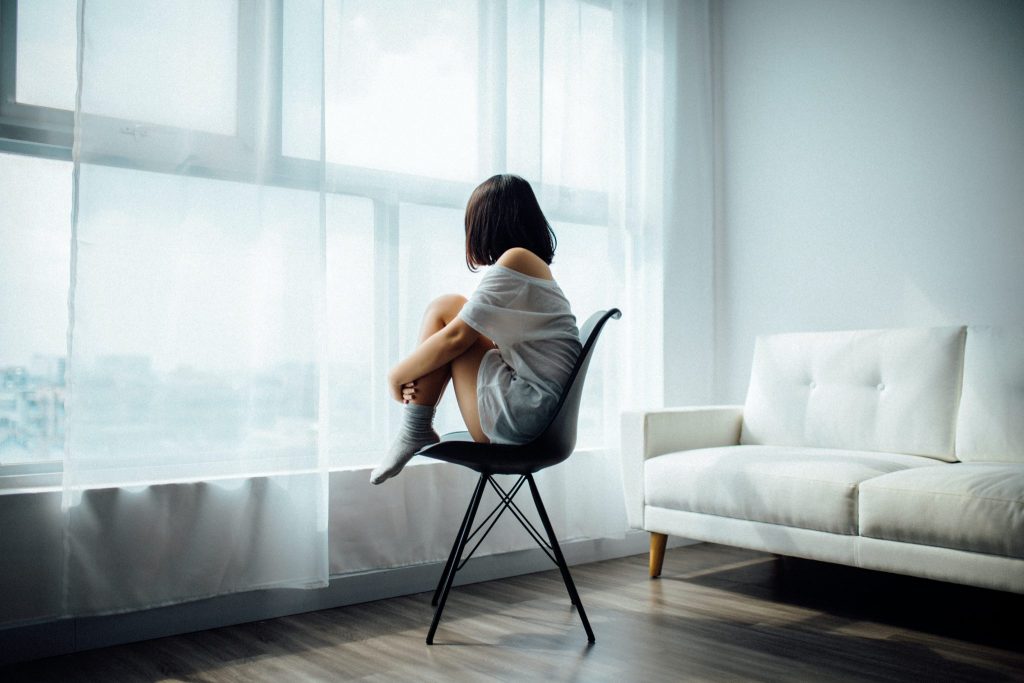 alcohol and depression, woman looking out a window