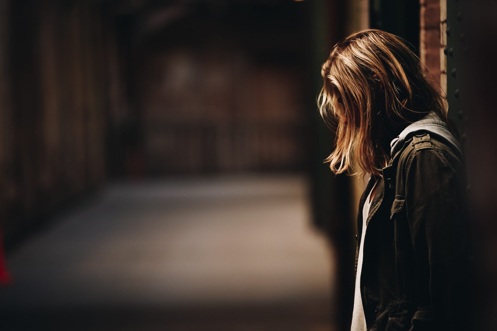 alcohol and mental health woman leaning on wall