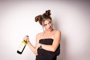 woman holding wine bottle 7 types of drunks