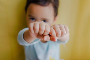 child with fists up secondhand drinking