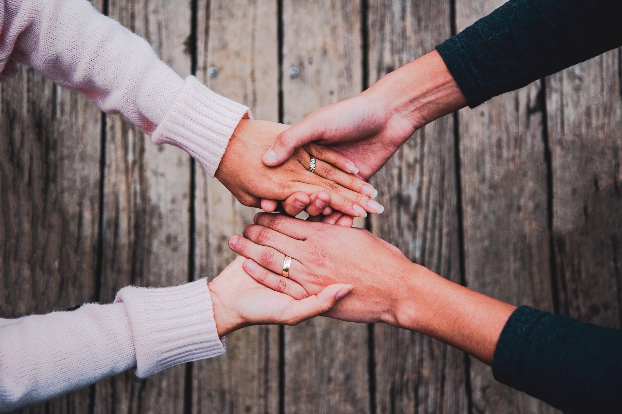 two people holding hands how to stay sober when your spouse still drinks