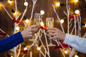 two women toasting glasses, coping with family drinking at holiday gatherings