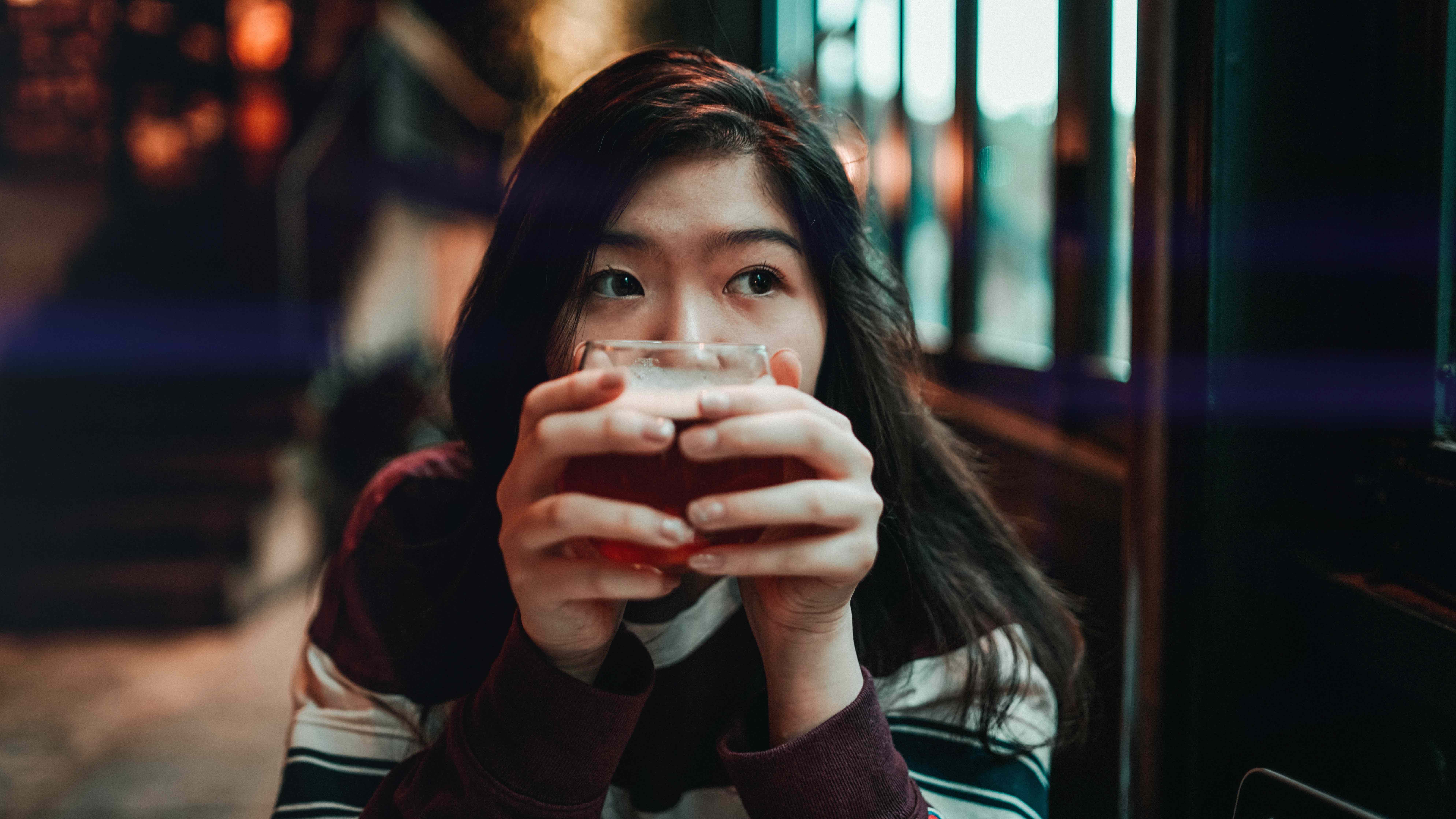 woman holding glass maladaptive behavior