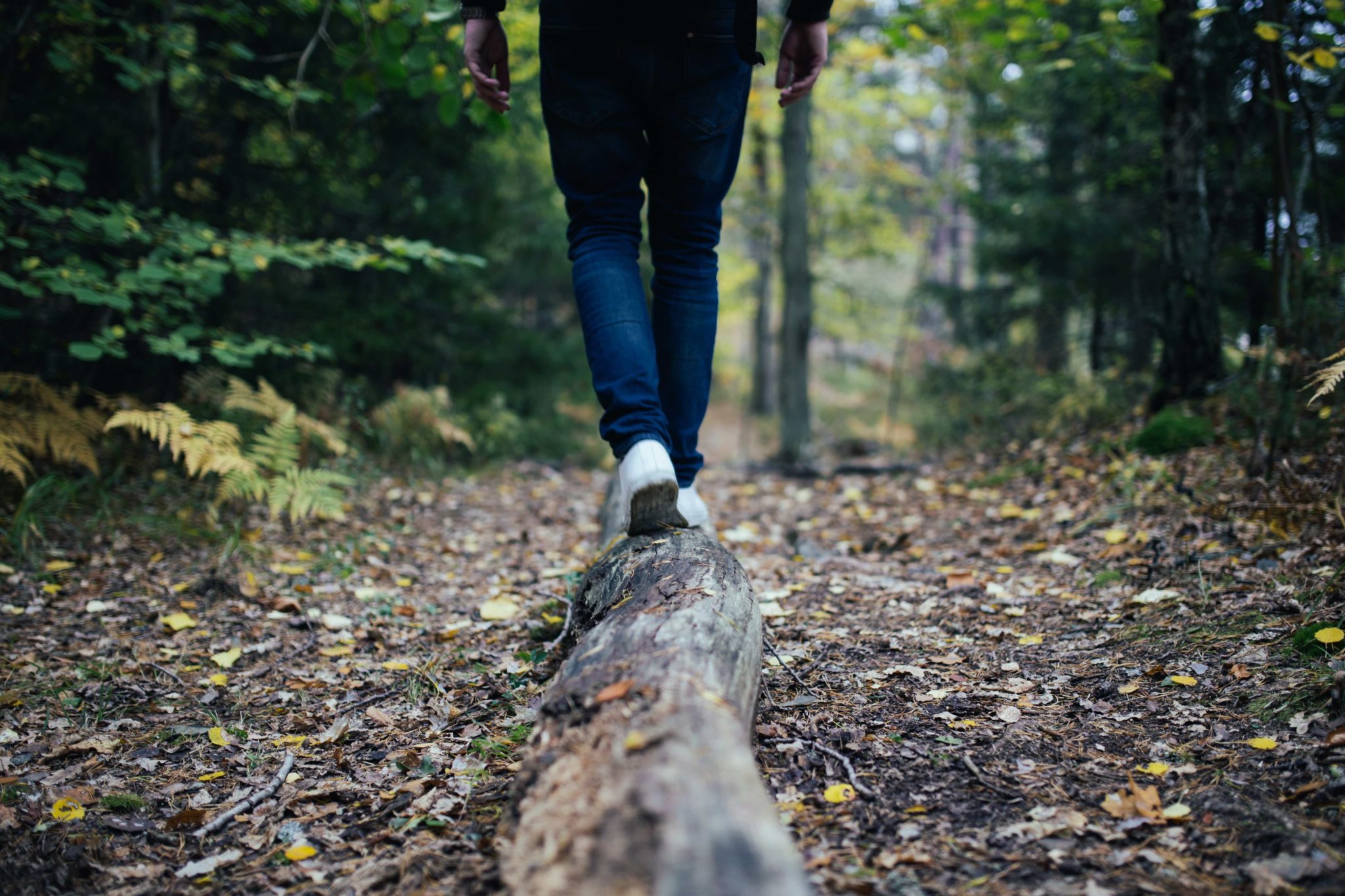 man balanced on log, dealing with triggers in recovery