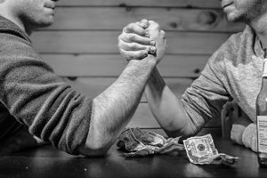 two men arm wrestling angry drunk