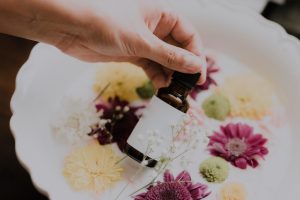 essential oils for alcoholism, hand holding bottle