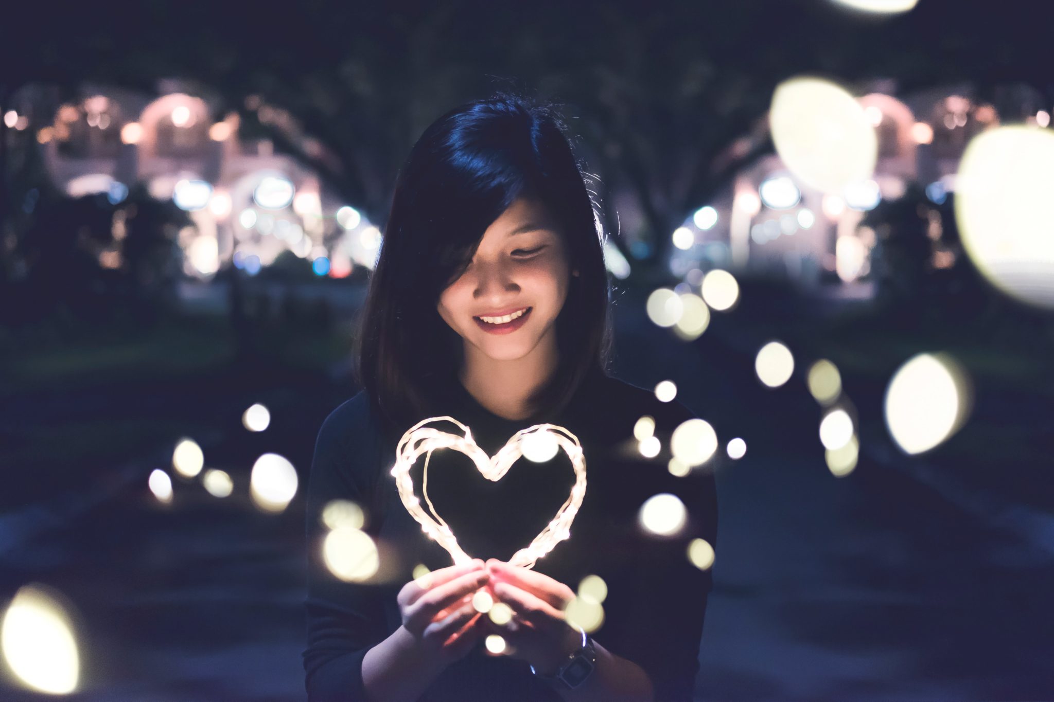 woman holding a decorative heart, self care in recovery