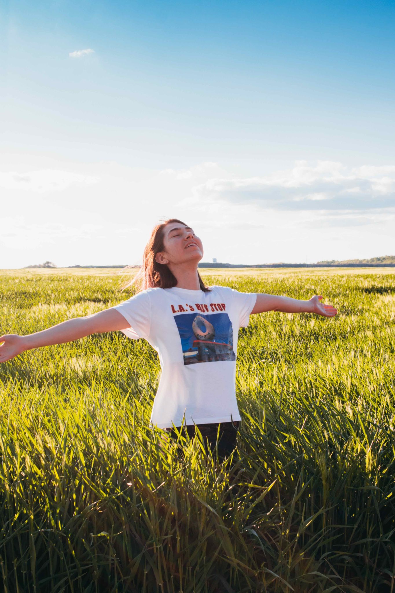 woman standing in a field, self care in recovery
