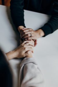 people holding hands treating anxiety and alcohol addiction