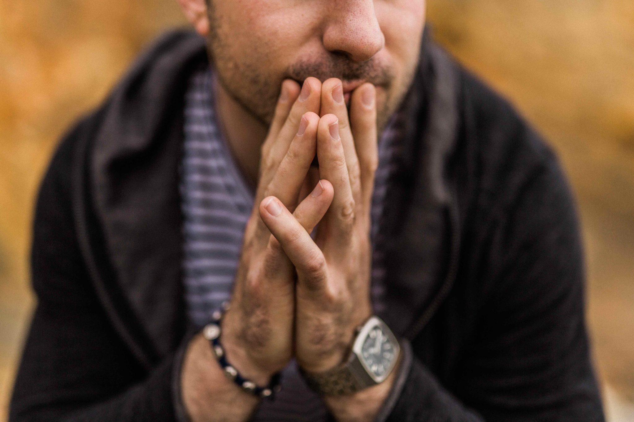 man sitting with folded hands treating anxiety and alcohol addiction