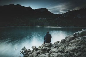 man sitting by water, treating depression and alcohol addiction