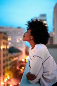 woman overlooking the city, taking a moment to be mindful