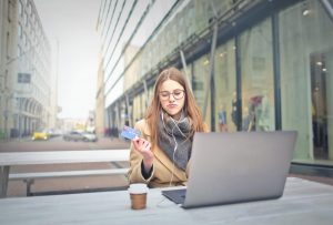 woman on computer with credit card