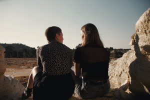 two people talking overlooking a landscape