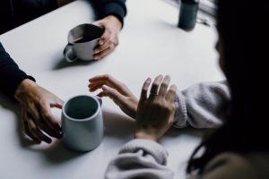 people having a discussion over coffee