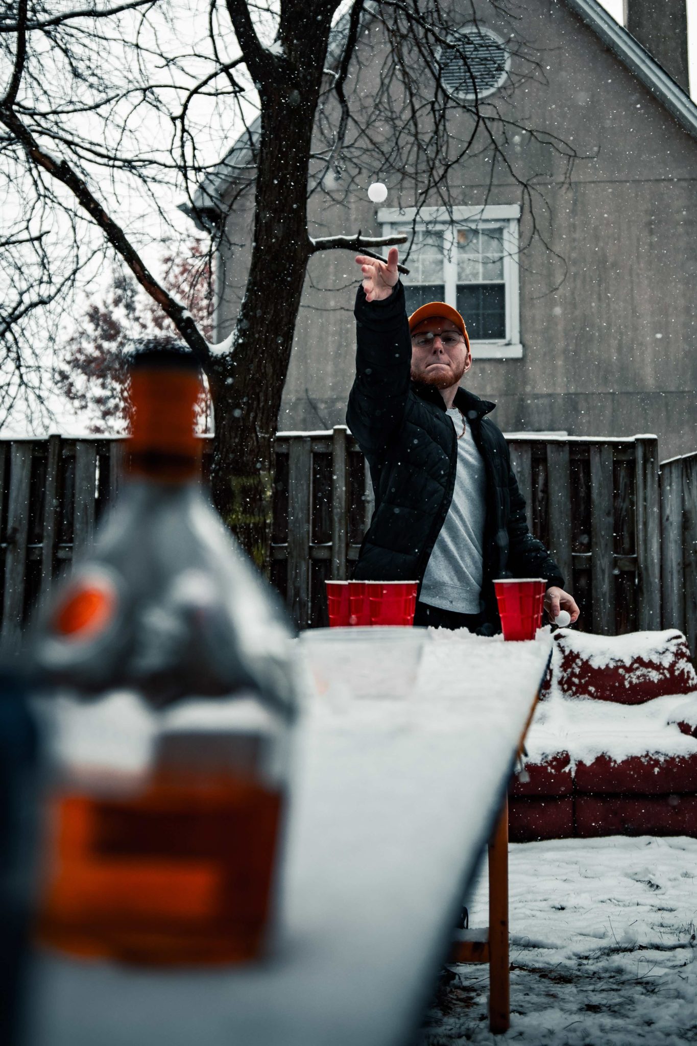 fraternity brother playing beer pong in the snow