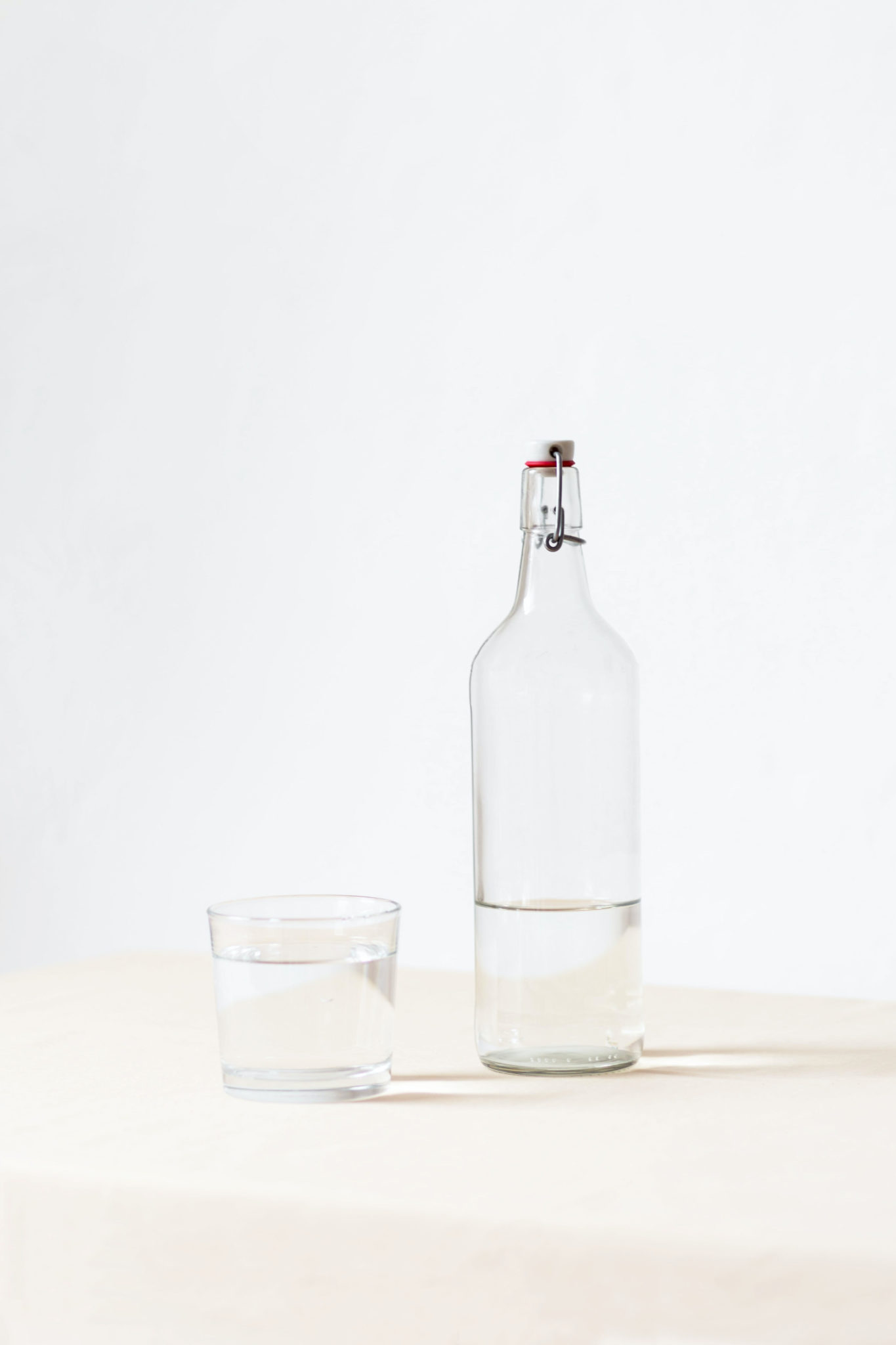 water bottle and glass, water helps flush your liver