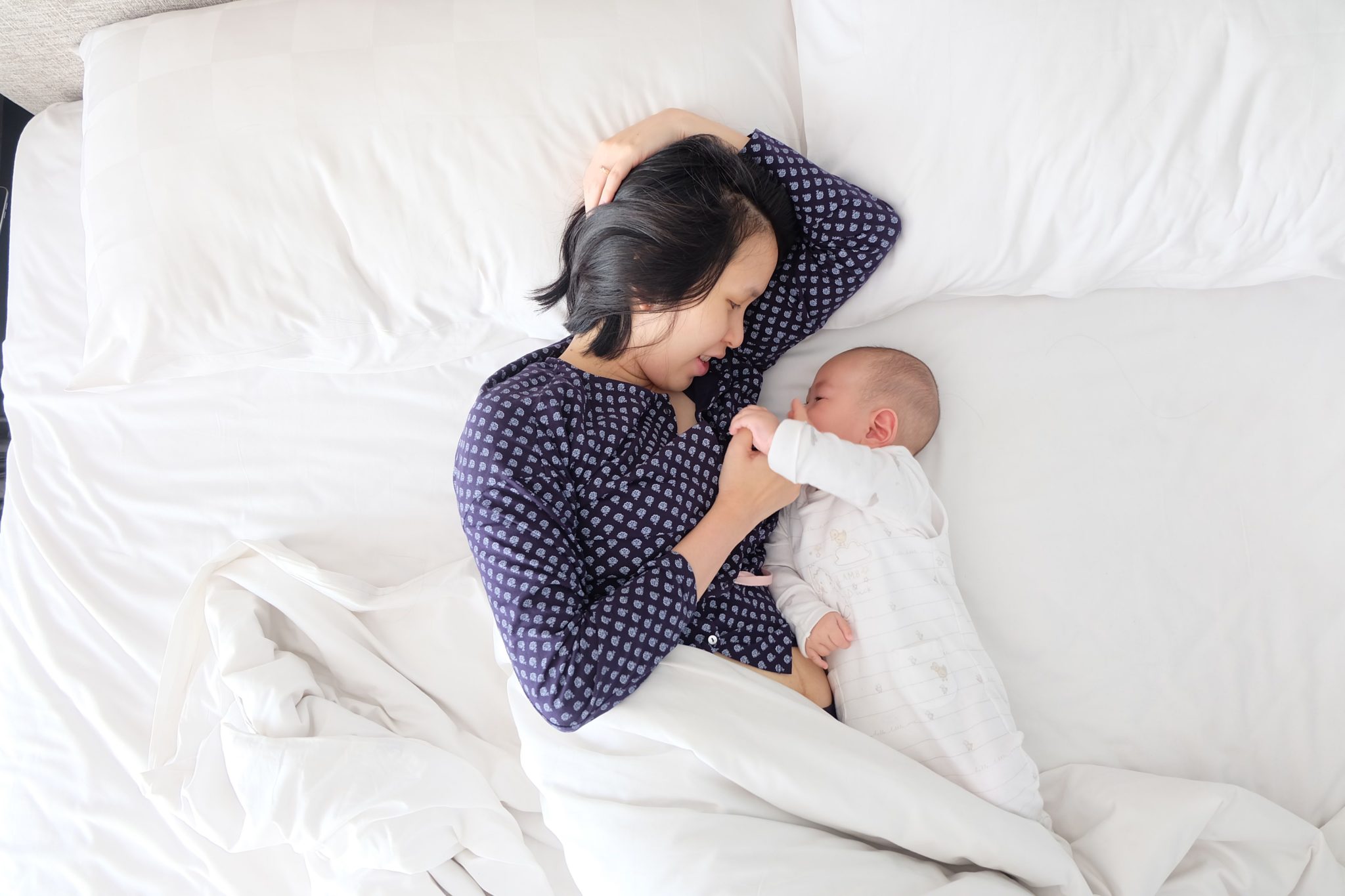 mother and child lying in bed