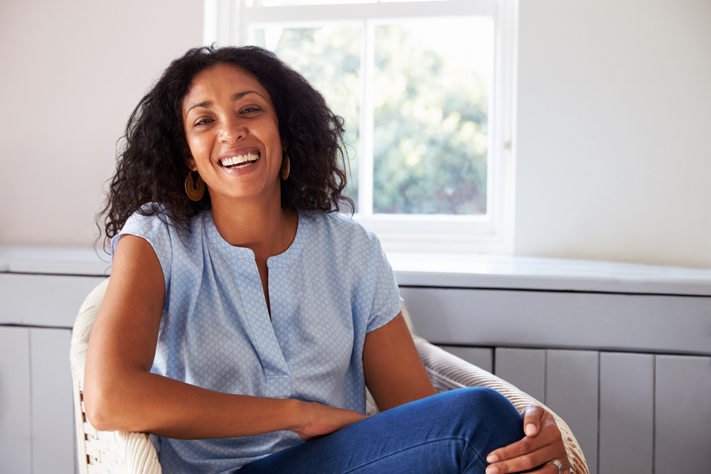 woman sitting in chair and smiling