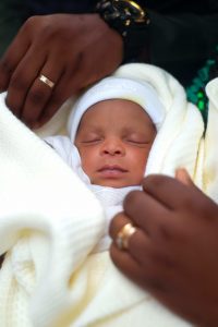 infant in their parent's hands