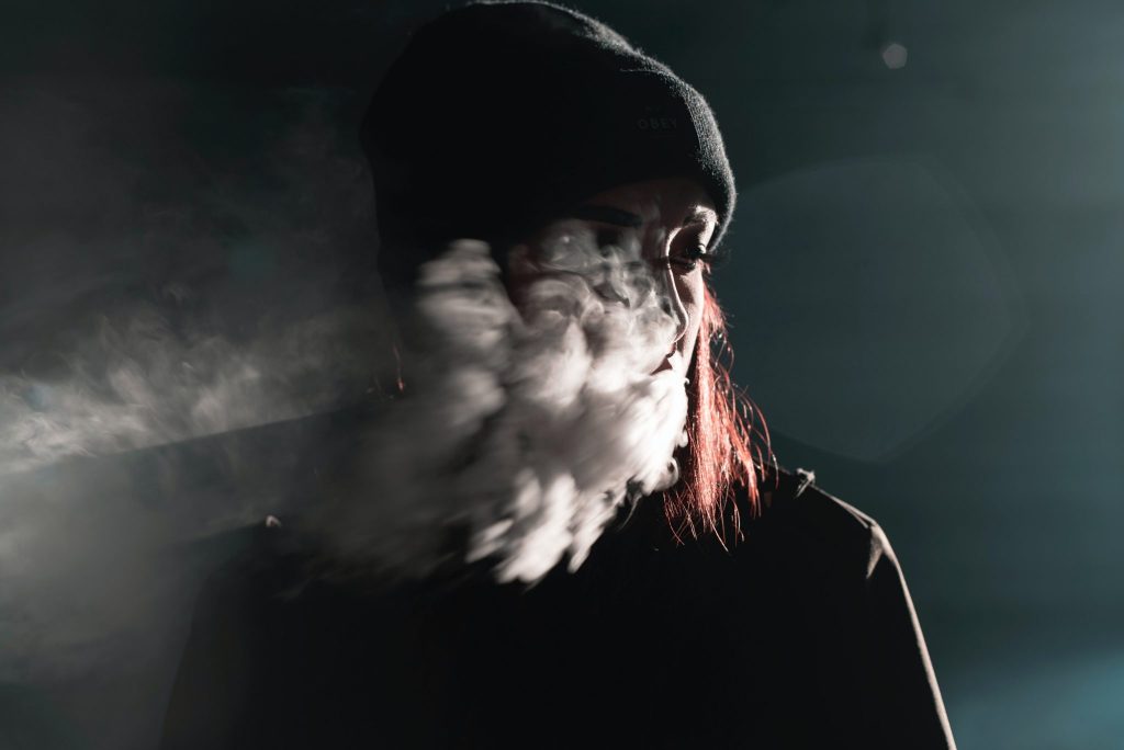 smoke cloud passing over a woman's face