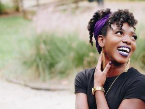 woman with purple lipstick smiling