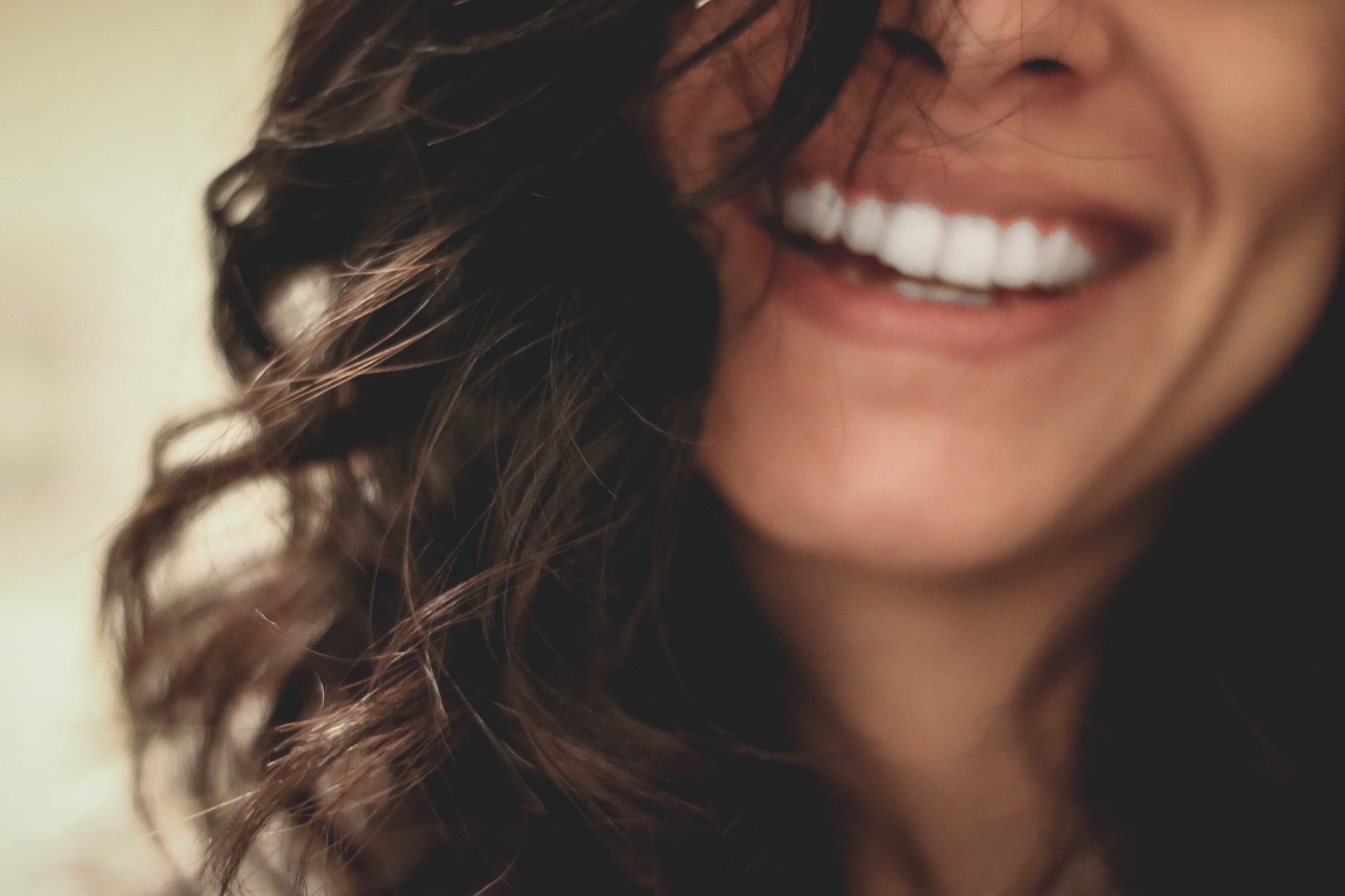 closeup of a woman with long hair smiling