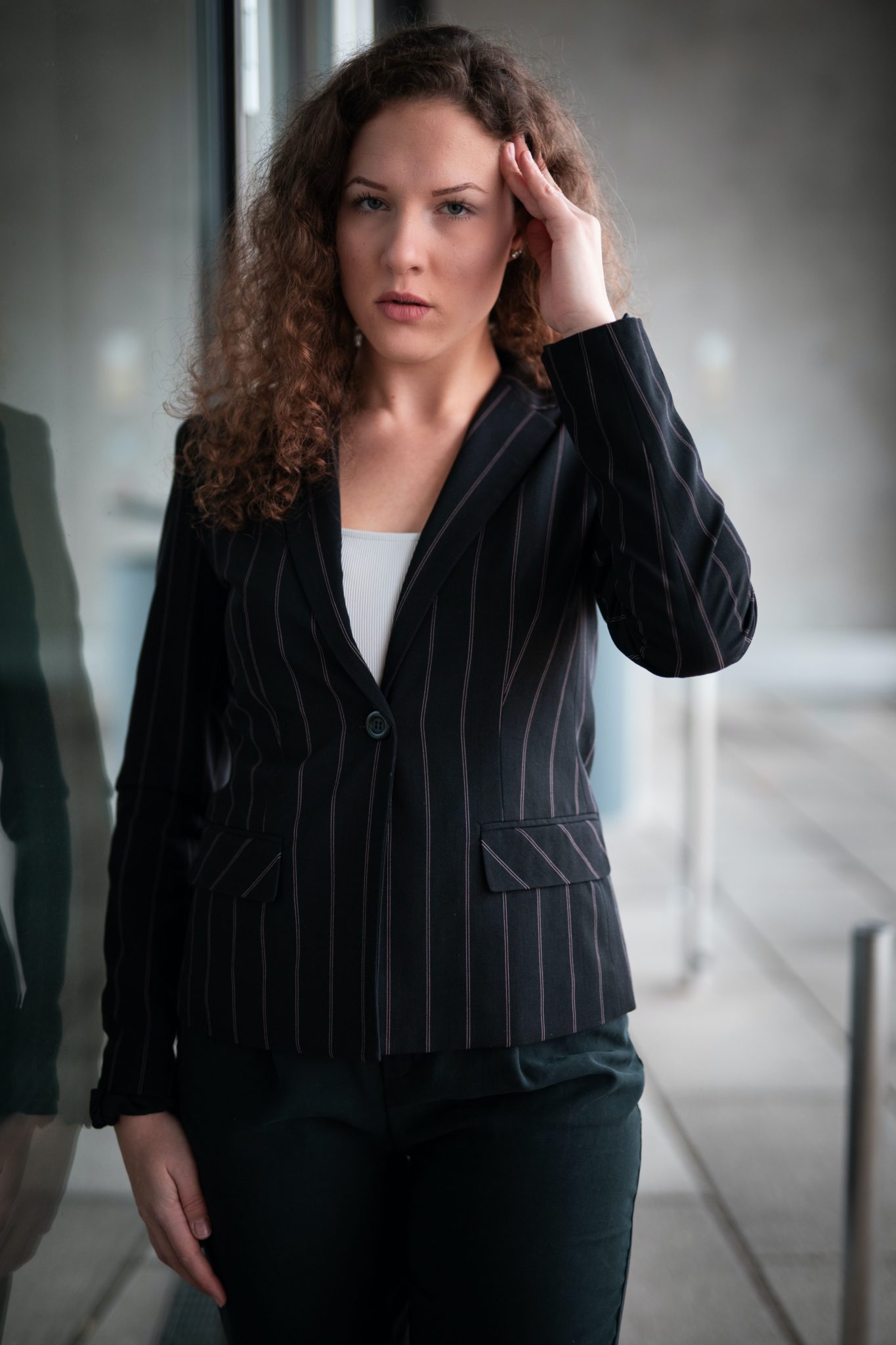 businesswoman in striped suit with a headache