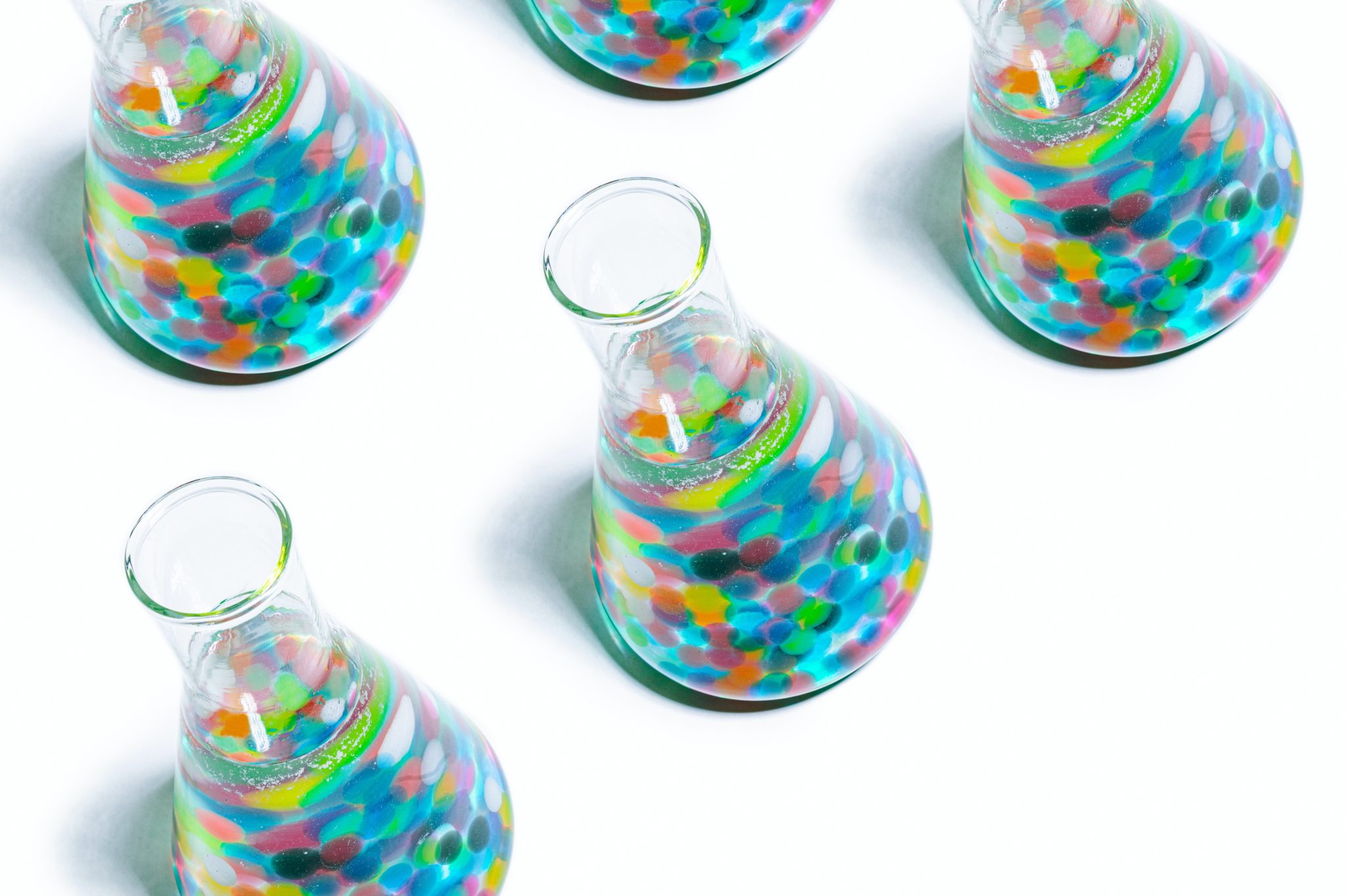 beakers filled with colorful marbles and liquid